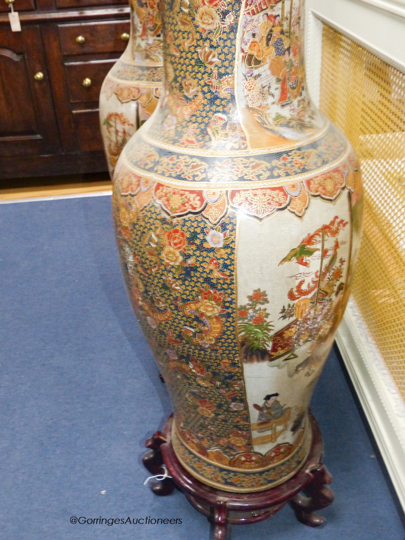 A pair of large Japanese vases, on hardwood stands